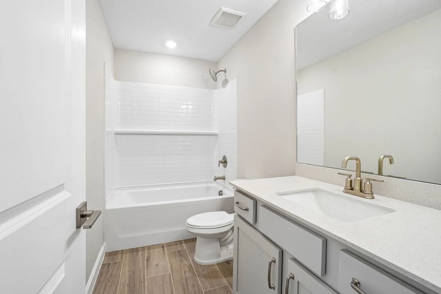 Bathroom 2 shared by the secondary bedrooms features aspects of AW Collection® Milan