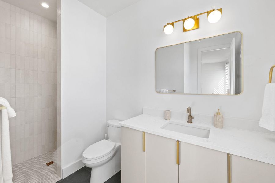 Bathroom with a walk in shower, vanity, recessed lighting, and tile patterned floors
