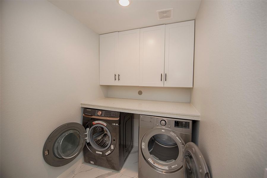 Utility room with space for your front loading washer and dryer. Great folding table top and amazing storage for your laundry essentials. Utility room with space for your front loading washer and dryer. Great folding table top and amazing storage for your laundry essentials.