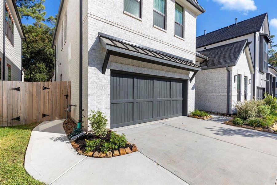 The side of the home features a concrete walkway with gate access, providing convenient entry to both the backyard and front yard.