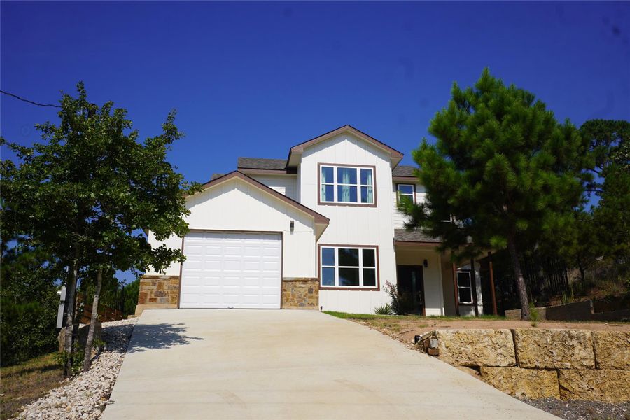 Welcome to 108 Kimo Ct in Bastrop — a fresh and modern two-story with crisp white siding, stone accents, and big windows that fill the home with natural light. The wide driveway leads to a spacious two-car garage, and the home sits on a quiet cul-de-sac surrounded by trees for extra privacy. From the moment you pull up, this place feels open, inviting, and ready for its next owners.