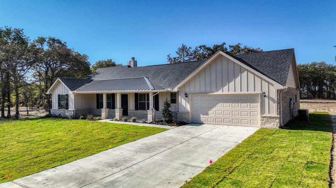 Front exterior of a new home in , Poolville, TX, highlighting curb appeal (Image 1).
