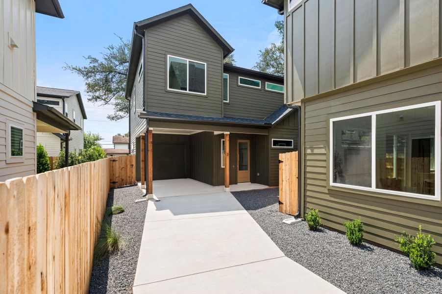 A contemporary exterior showcasing a covered carport and a sleek design with ample natural light. A contemporary exterior showcasing a covered carport and a sleek design with ample natural light.