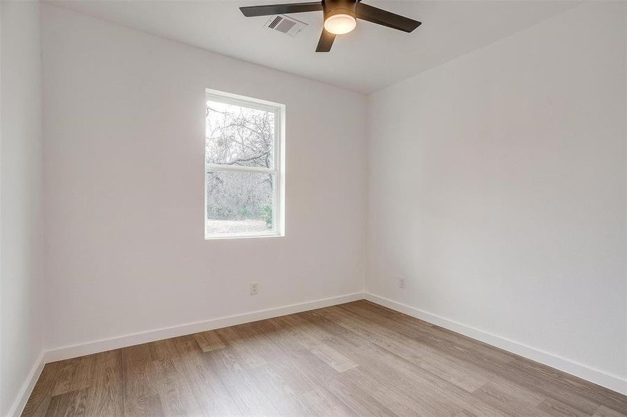 Bedroom 2 featuring ceiling fan and light hardwood / wood-style flooring Bedroom 2 featuring ceiling fan and light hardwood / wood-style flooring