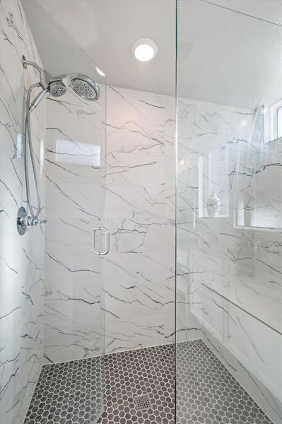 Bathroom featuring a marble finish shower