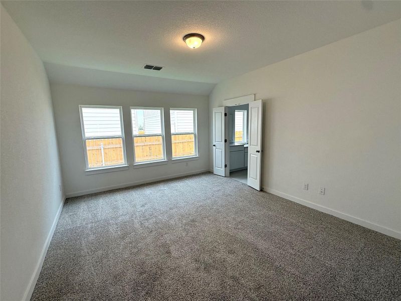 Unfurnished bedroom featuring carpet floors and lofted ceiling Unfurnished bedroom featuring carpet floors and lofted ceiling