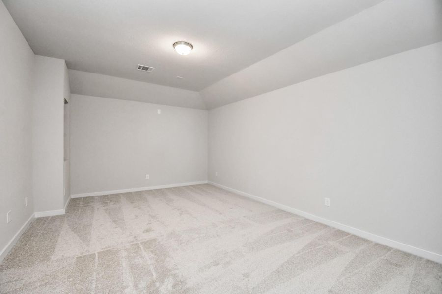 Secondary bedroom features plush carpeting, large windows that let in plenty of natural light, bright paint, and spacious closets. Sample photo of completed home with similar floor plan. Actual colors and selections may vary.