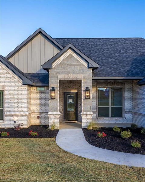 Entrance to property with a lawn