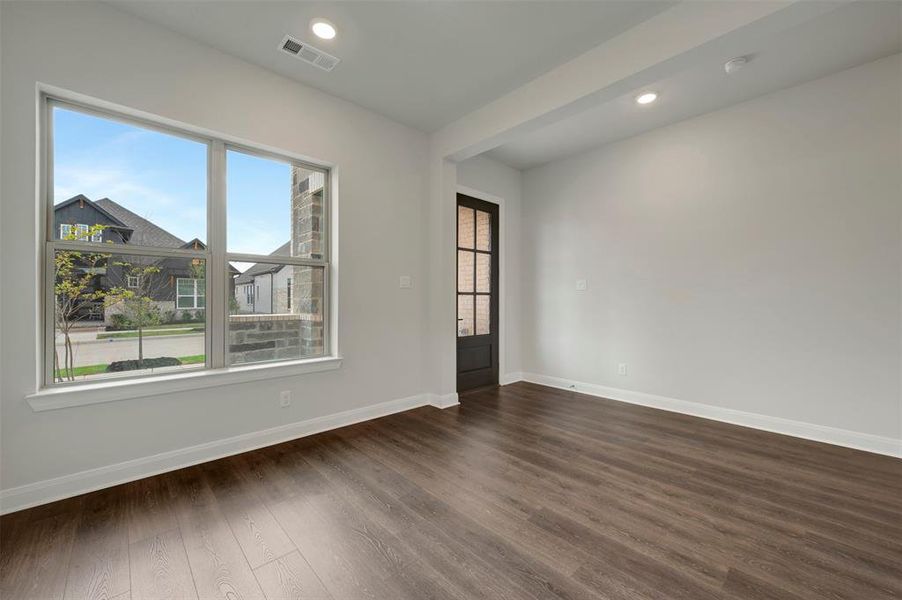Spare room featuring recessed lighting and dark wood finished floors