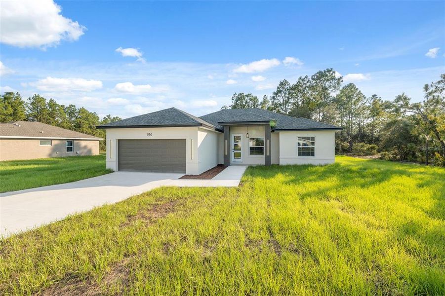 Front exterior of a new home in , Ocala, FL, highlighting curb appeal (Image 2).