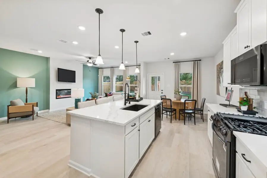 The Princeton II- Kitchen into the Family Room. Staged model home shown for illustration only; actual features, colors, and upgrades may vary.