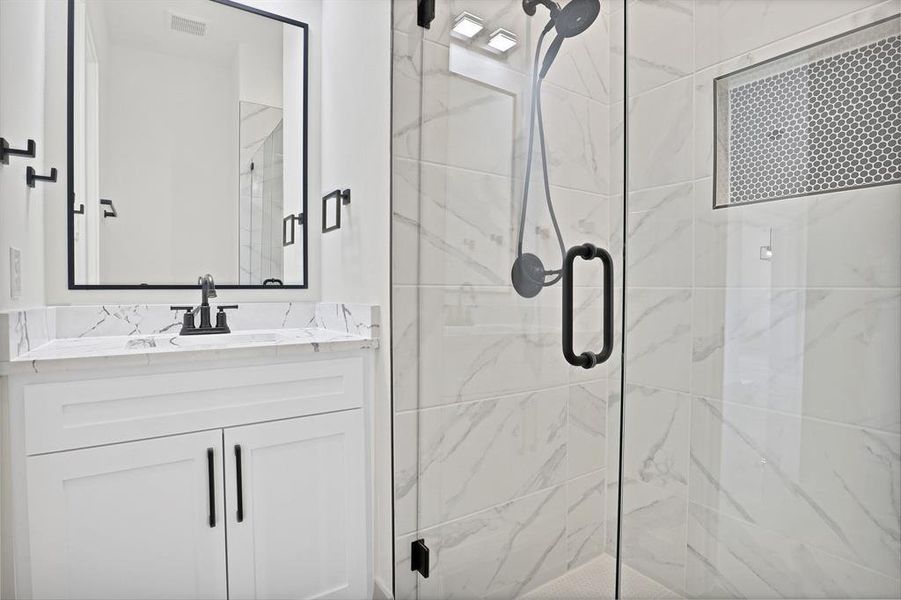 Bathroom featuring vanity and walk in shower