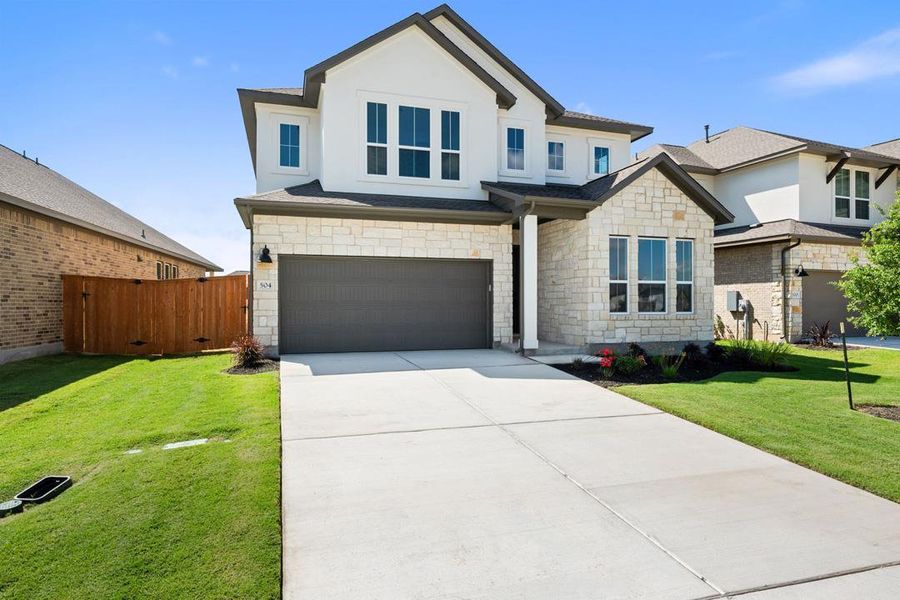 Front exterior of a new home in Lariat, Liberty Hill, TX, highlighting curb appeal (Image 2). Front exterior of a new home in Lariat, Liberty Hill, TX, highlighting curb appeal (Image 2).