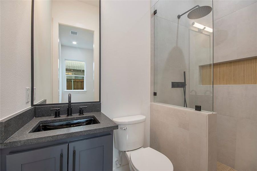 Bathroom with a walk in shower and vanity