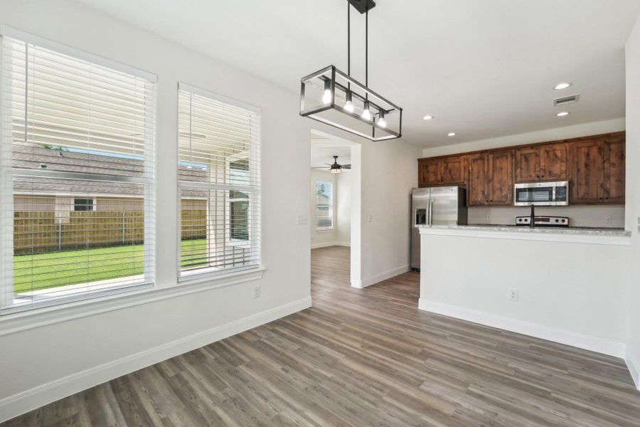 Virtually Staged Breakfast area with recessed lighting, wood-style vinyl flooring, visible vents, baseboards, and ceiling fan Virtually Staged Breakfast area with recessed lighting, wood-style vinyl flooring, visible vents, baseboards, and ceiling fan