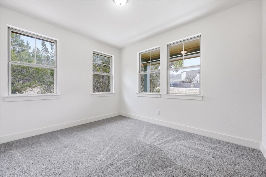 Empty room featuring carpet flooring and baseboards