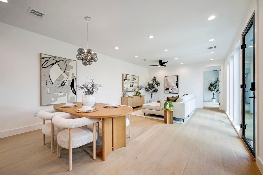 Dining space with recessed lighting, light wood finished floors, a ceiling fan, and a chandelier