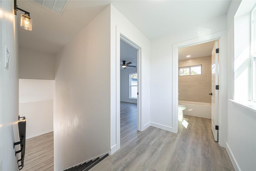 Hallway featuring light wood-style floors and baseboards