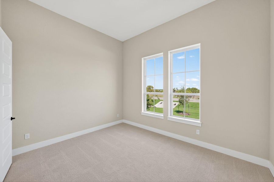 Empty room featuring light colored carpet and baseboards Empty room featuring light colored carpet and baseboards