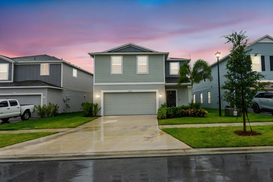 Front exterior of a new home in , Port St. Lucie, FL, highlighting curb appeal (Image 2).