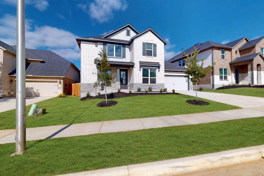 Front exterior of a new home in Edgewood, Leander, TX, highlighting curb appeal (Image 21).