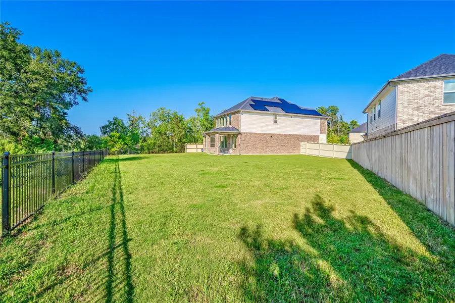 Exterior details and patio area of a home in Harper's Preserve - Classic Series, Conroe (Image 2). Exterior details and patio area of a home in Harper's Preserve - Classic Series, Conroe (Image 2).