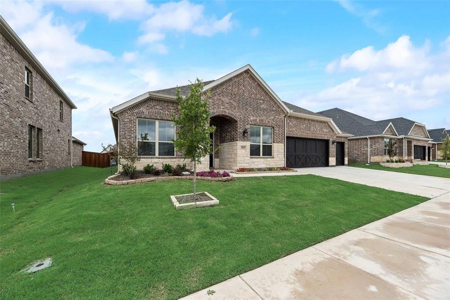Front exterior of a new home in Sutton Fields, Celina, TX, highlighting curb appeal (Image 17).
