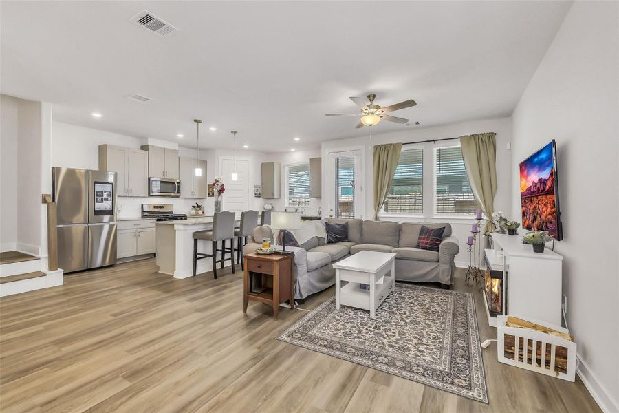 Spacious open-concept living area designed for both everyday comfort and effortless entertaining with seamless flow into the kitchen and dining areas.