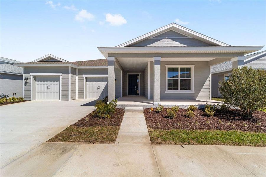 Front exterior of a new home in Calesa Township, Ocala, FL, highlighting curb appeal (Image 22). Front exterior of a new home in Calesa Township, Ocala, FL, highlighting curb appeal (Image 22).