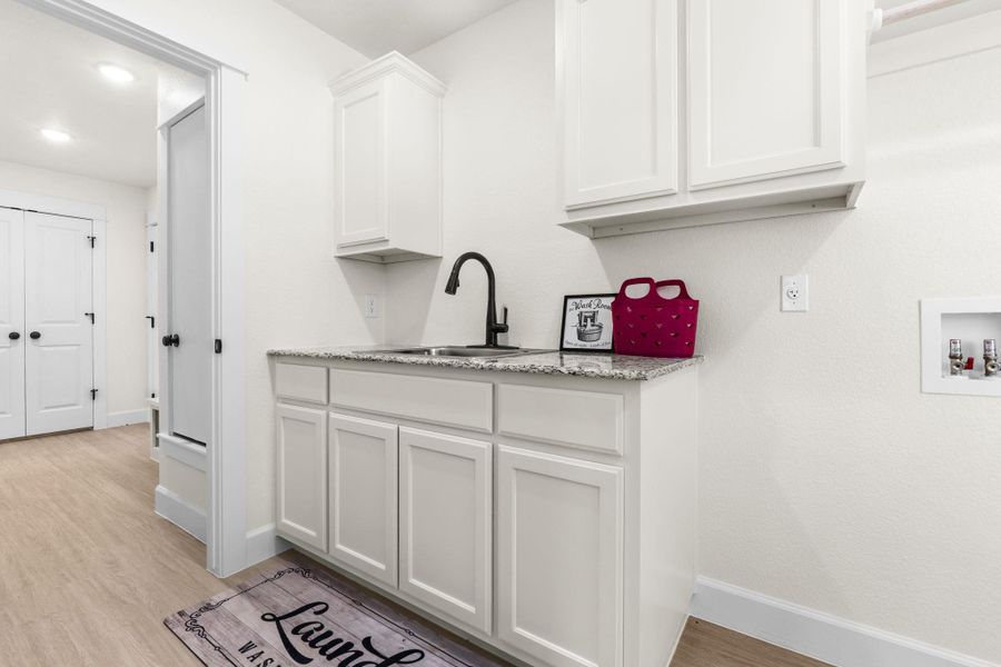 Laundry room with light wood finished floors and washer hookup