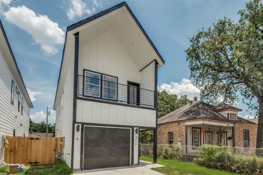 Contemporary home with a balcony and a garage