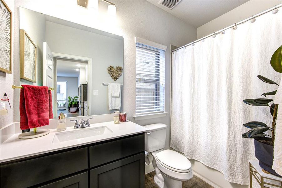 Conveniently located downstairs guest bedroom offers comfort and privacy.