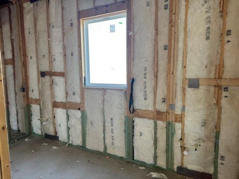 A well-insulated room, framed and ready for finishing, awaits customization.
