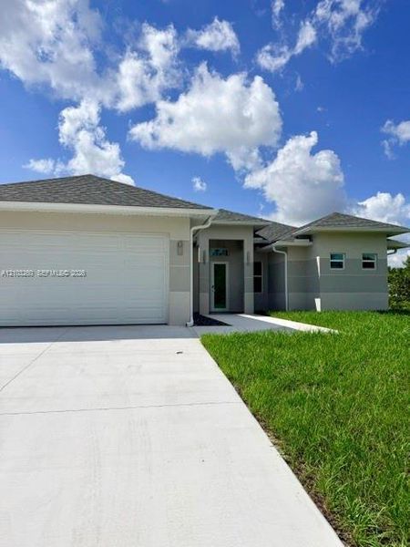 Front exterior of a new home in , Lehigh Acres, FL, highlighting curb appeal (Image 20).