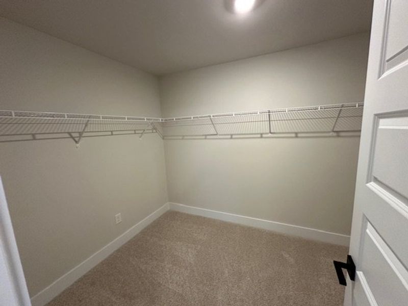 This spacious walk-in closet offers ample storage