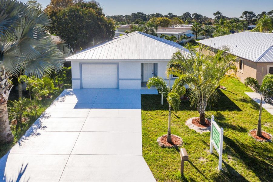 Front exterior of a new home in , Port St. Lucie, FL, highlighting curb appeal (Image 1).