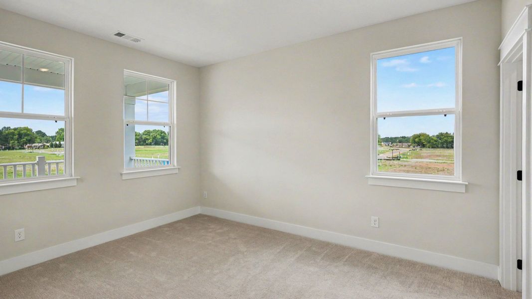Bedroom with carpet and windows Bedroom with carpet and windows
