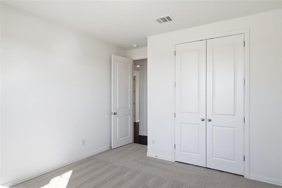 Neutral-toned carpet flooring complementing white walls and trim