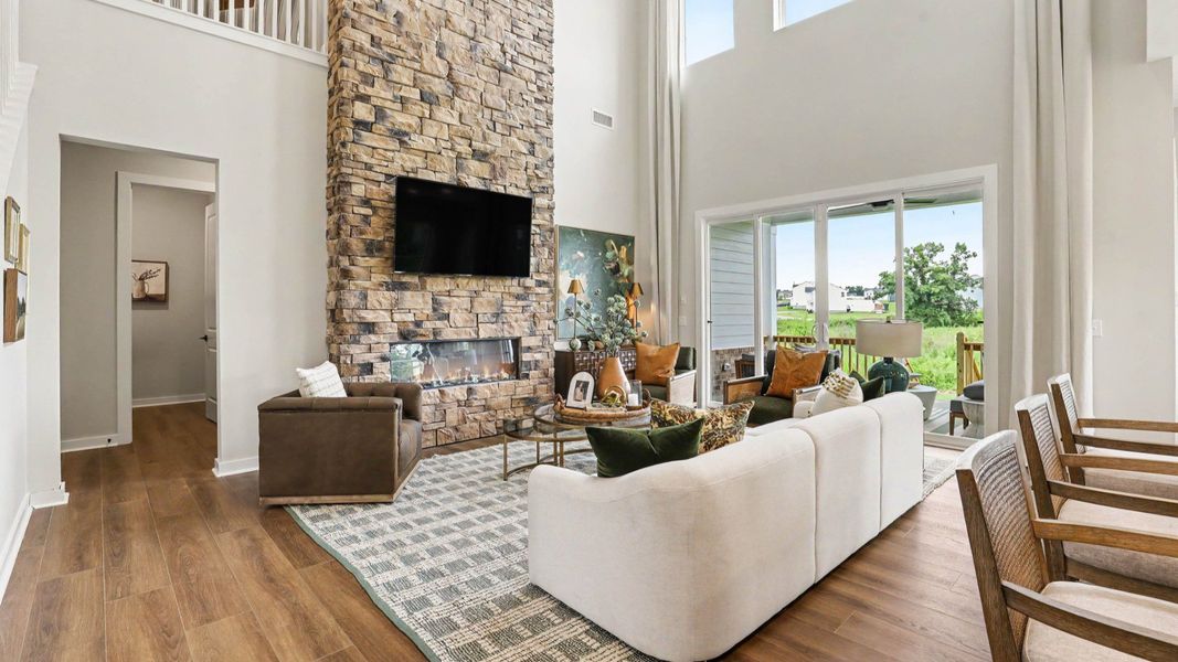 Gathering room with high ceilings and stone fireplace