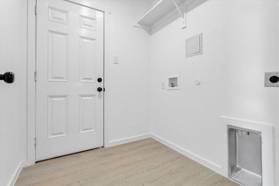 Laundry room featuring hookup for an electric dryer, gas dryer hookup, light hardwood / wood-style floors, and hookup for a washing machine