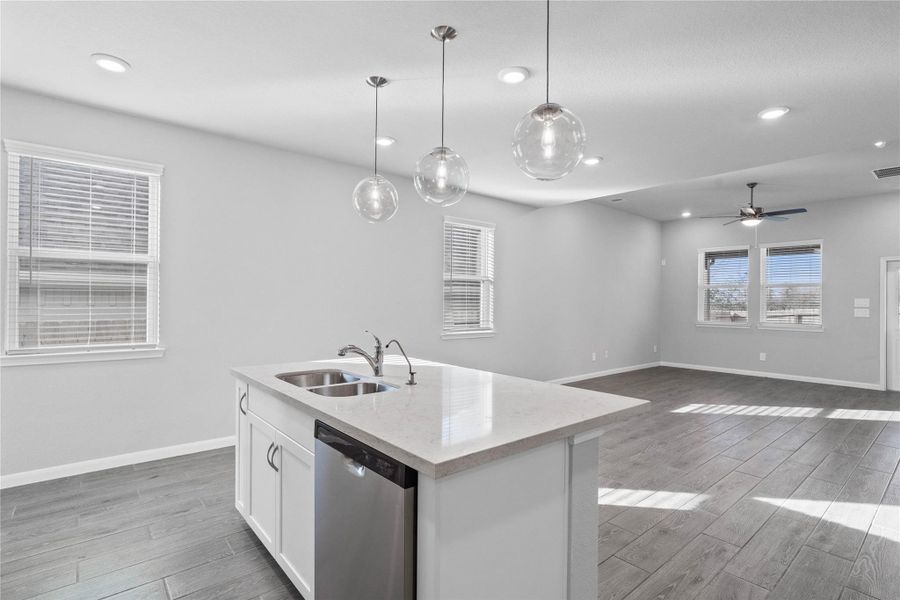 From the expansive kitchen island, enjoy seamless sightlines across the open-concept living and dining areas, making entertaining a breeze and ensuring you're never far from the conversation.
