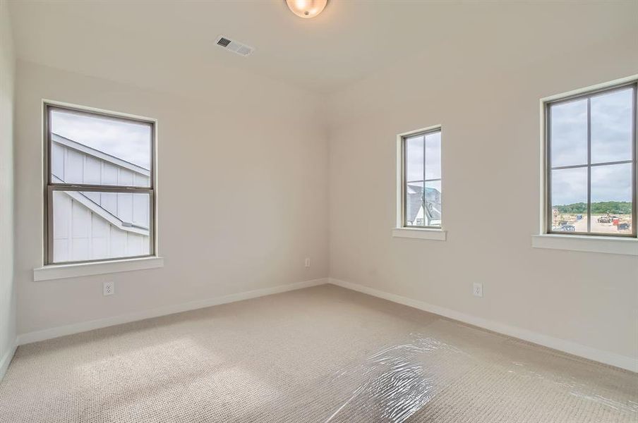 Spare room with carpet flooring and baseboards Spare room with carpet flooring and baseboards