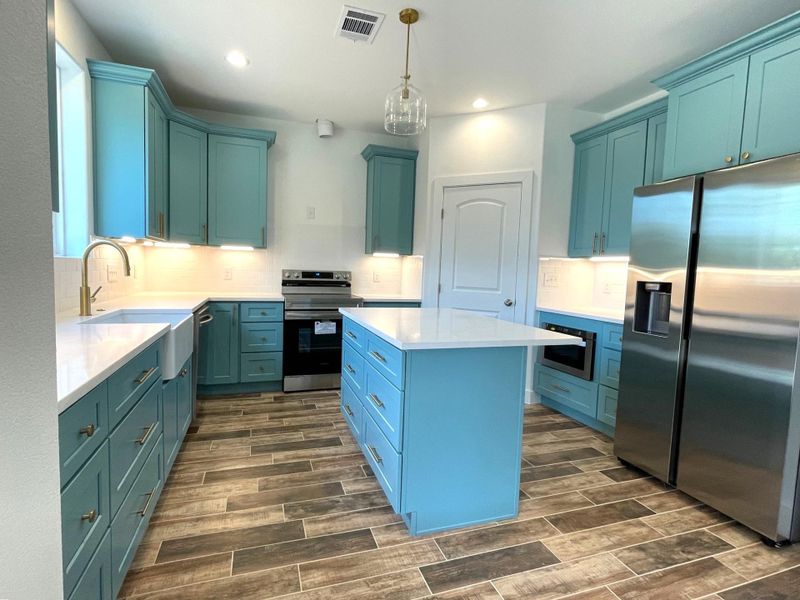 Kitchen with farm sink, disposal and dishwasher