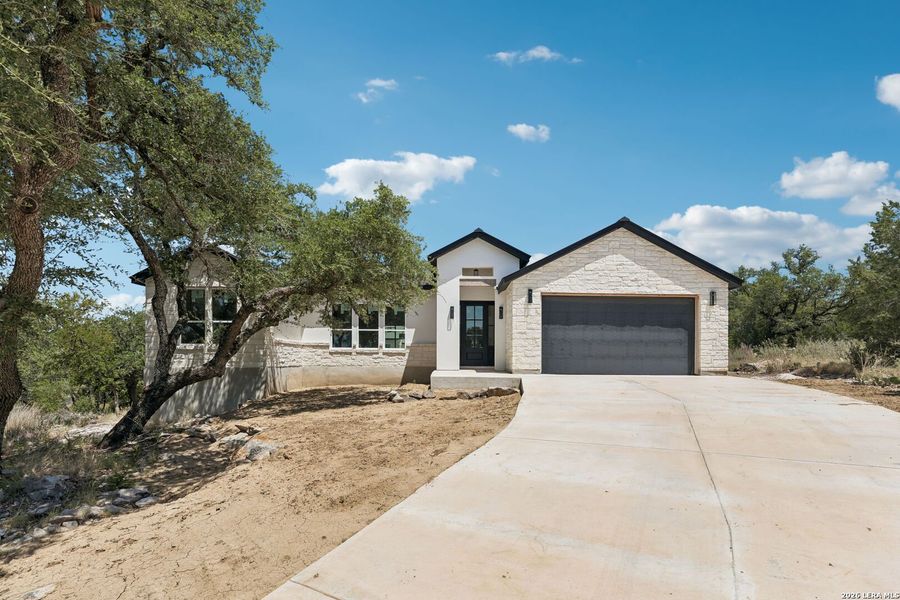 Front exterior of a new home in , Horseshoe Bay, TX, highlighting curb appeal (Image 2). Front exterior of a new home in , Horseshoe Bay, TX, highlighting curb appeal (Image 2).