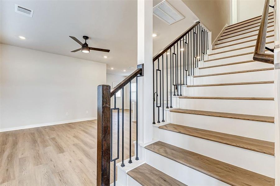 This sleek staircase with wrought-iron railings adds an architectural focal point, seamlessly blending with the open living area. The design offers a perfect balance of style and functionality.