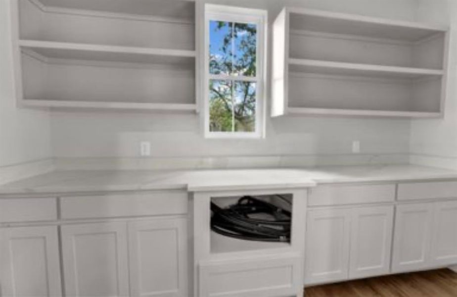 Kitchen featuring open shelves, white cabinets, and light wood-style floors