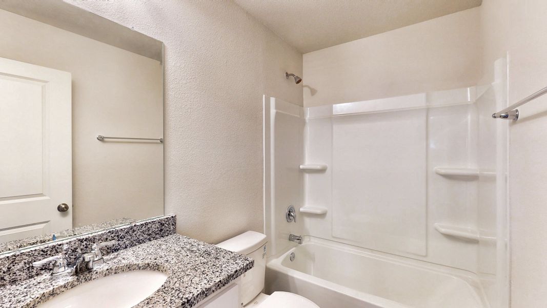 A bathroom with a marble countertop.