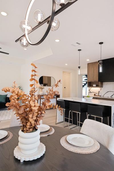 Dining space with recessed lighting, light wood-style floors, and a chandelier
