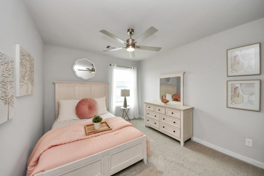 Generously sized secondary bedrooms featuring spacious closets, soft and inviting carpeting underfoot, large windows allowing plenty of natural light, and the added touch of privacy blinds for your personal retreat. Sample photo of completed home with similar floor plan. Actual colors and selections may vary.