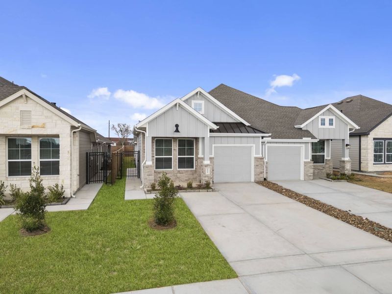 Front exterior of a new home in Meridiana, Manvel, TX, highlighting curb appeal (Image 21).